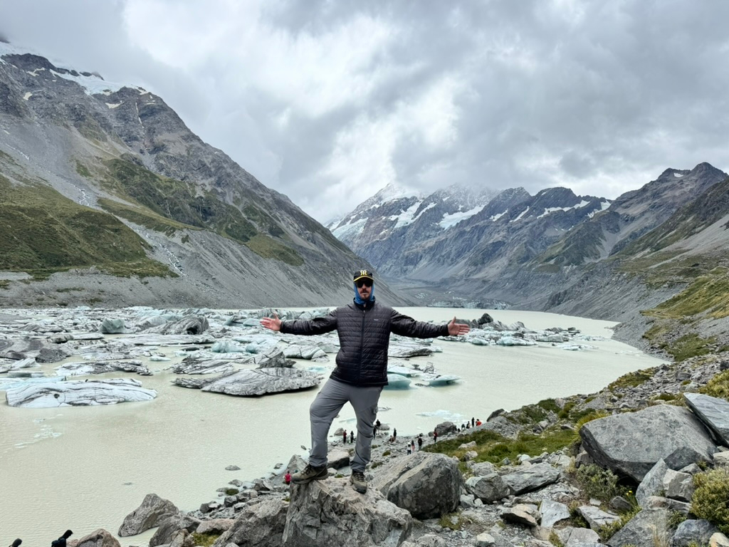 Man in front of Hooker Lake in New Zealand