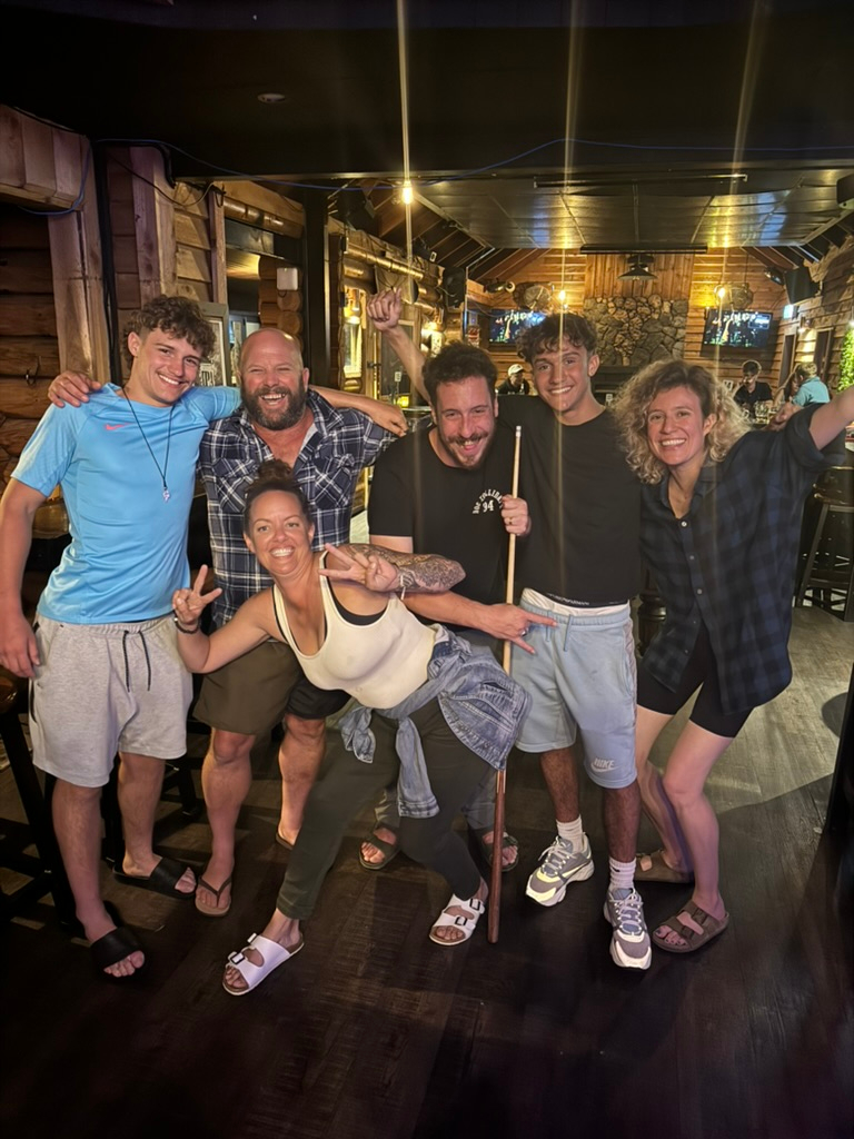 An eclectic group of people enjoying a game of pool at Monsoon Restaurant & Bar in Franz Josef, New Zealand