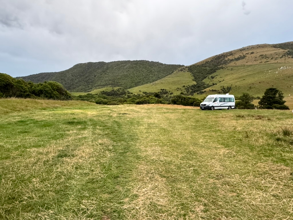 RV camping spot at Purakaunui Bay Campsite in New Zealand