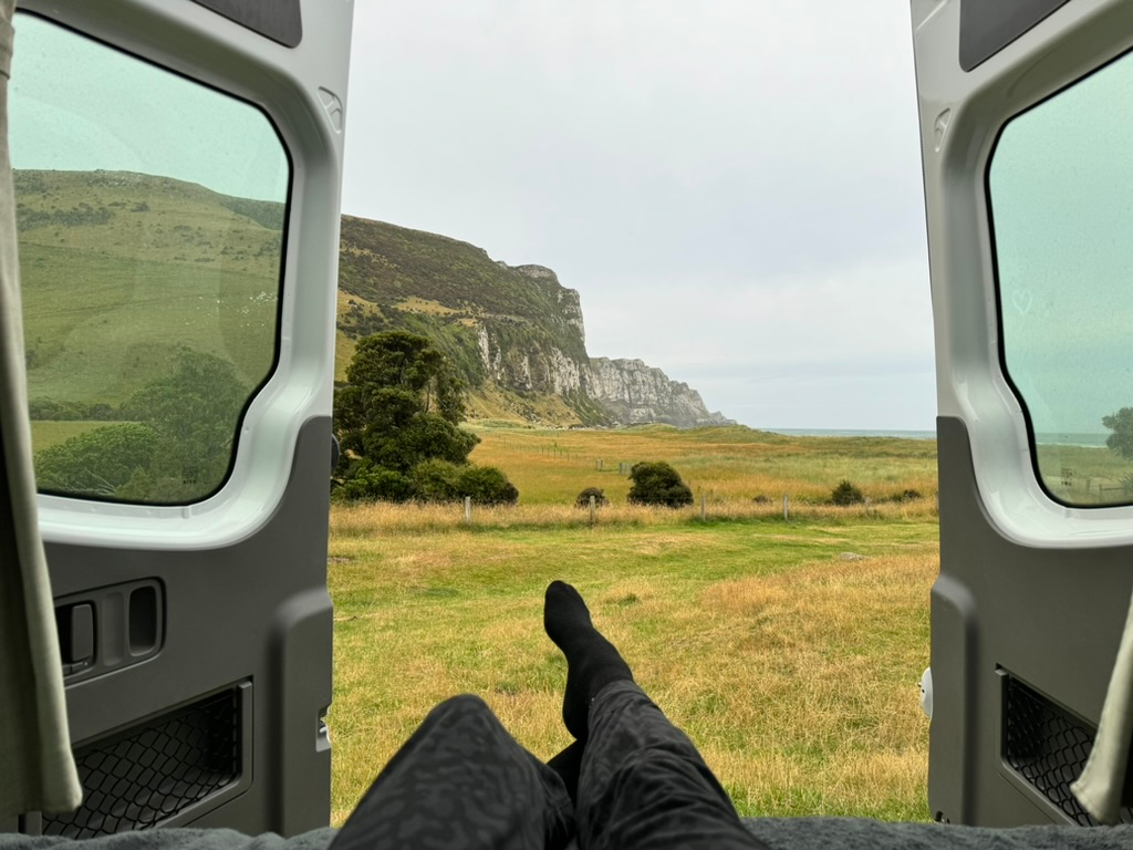 View out RV back door at Purakaunui Bay Campsite in New Zealand