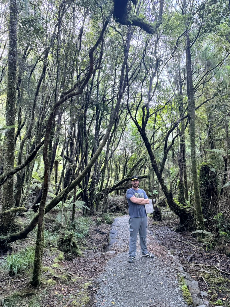 A man on Wharekai Te Kou Walk in Jackson Bay, New Zealand