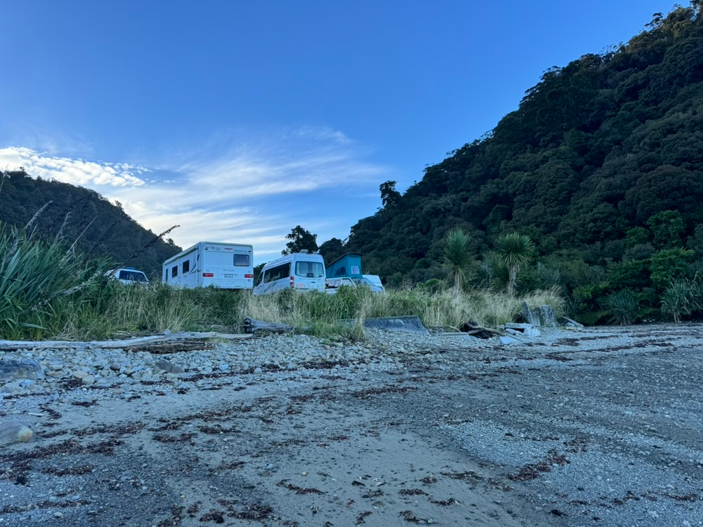 RVs and campervans parked at Jackson Bay freedom camping in New Zealand