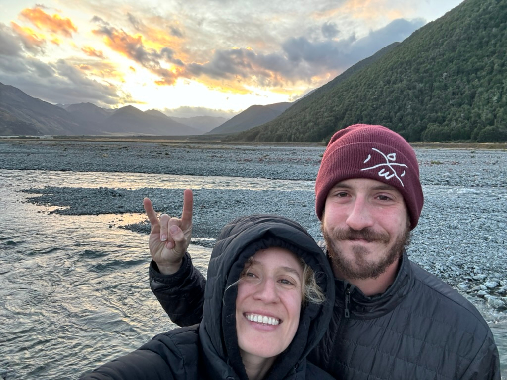 Couple in front of scenery at Hawdon Shelter Campgrounds in New Zealand