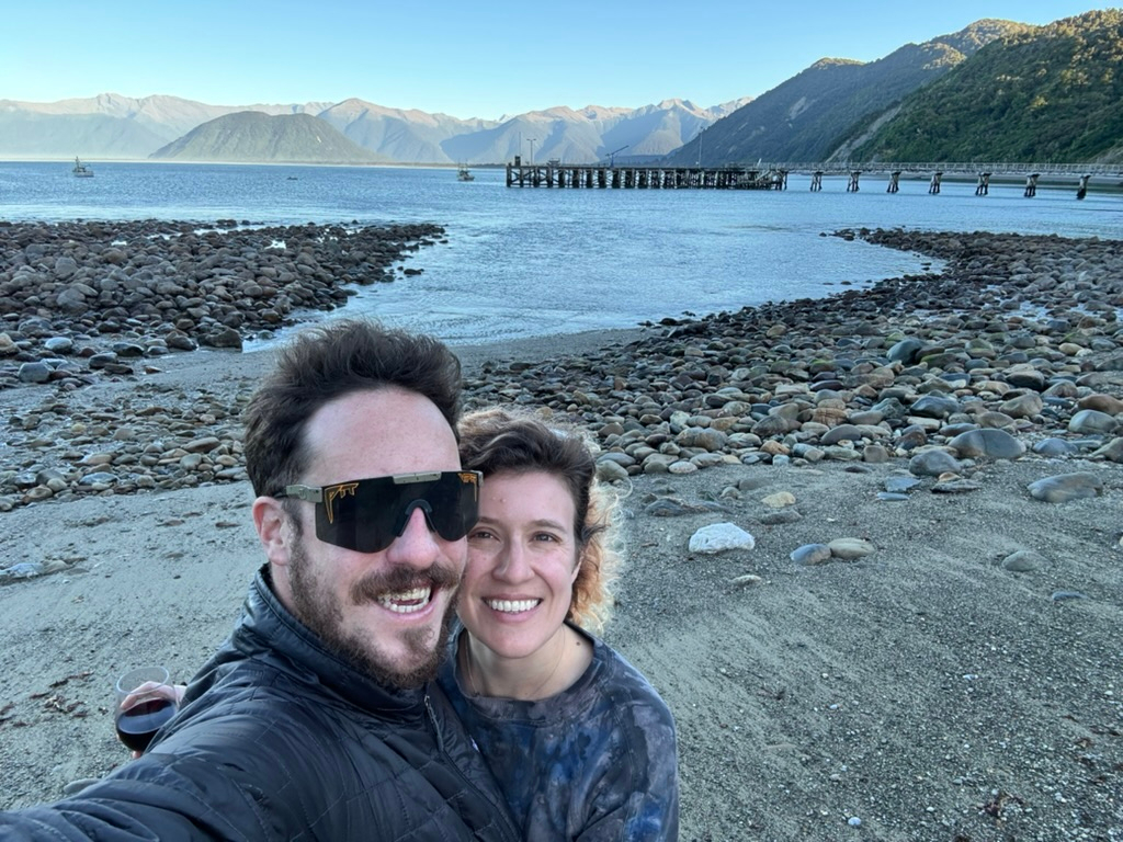 A couple on the beach in Jackson Bay, New Zealand