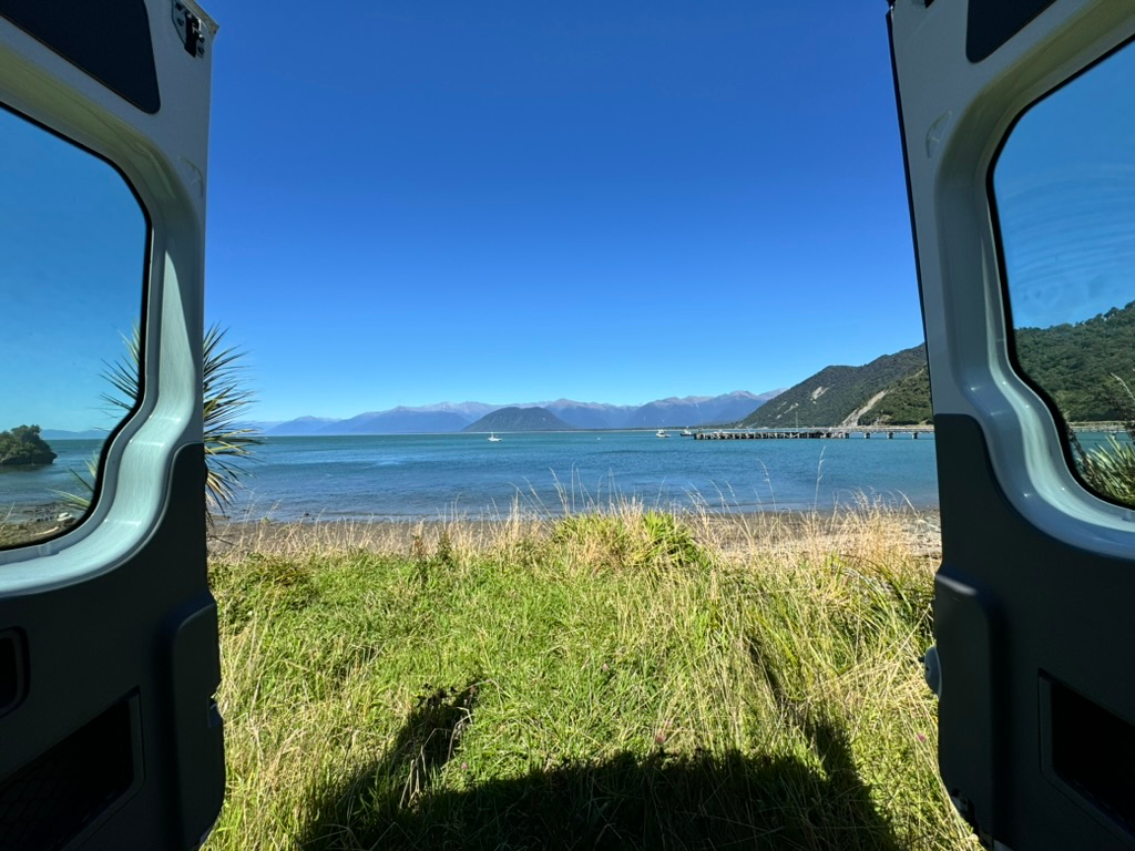 View out RV back door at Jackson Bay freedom camping in New Zealand