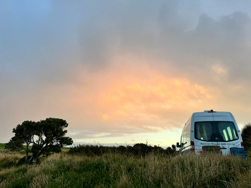 RV amidst sunset at Monkey Beach freedom camping in New Zealand