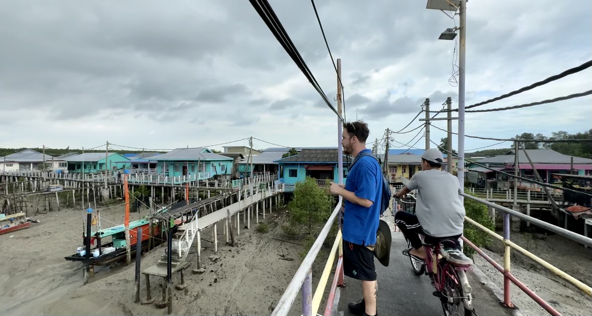 Man taking in view on Crab Island, Malaysia while tide is out