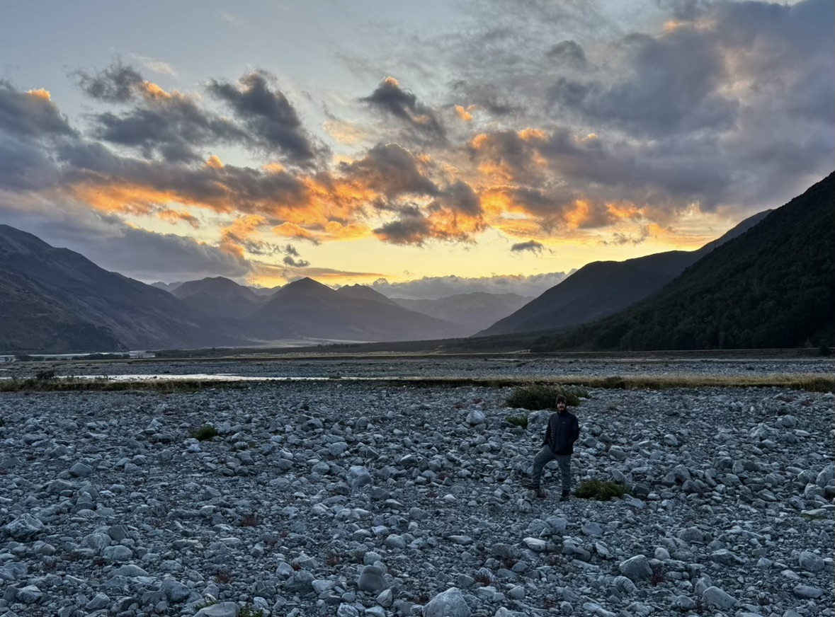 Man in front of stunning views at Hawdon Shelter Campground in New Zealand