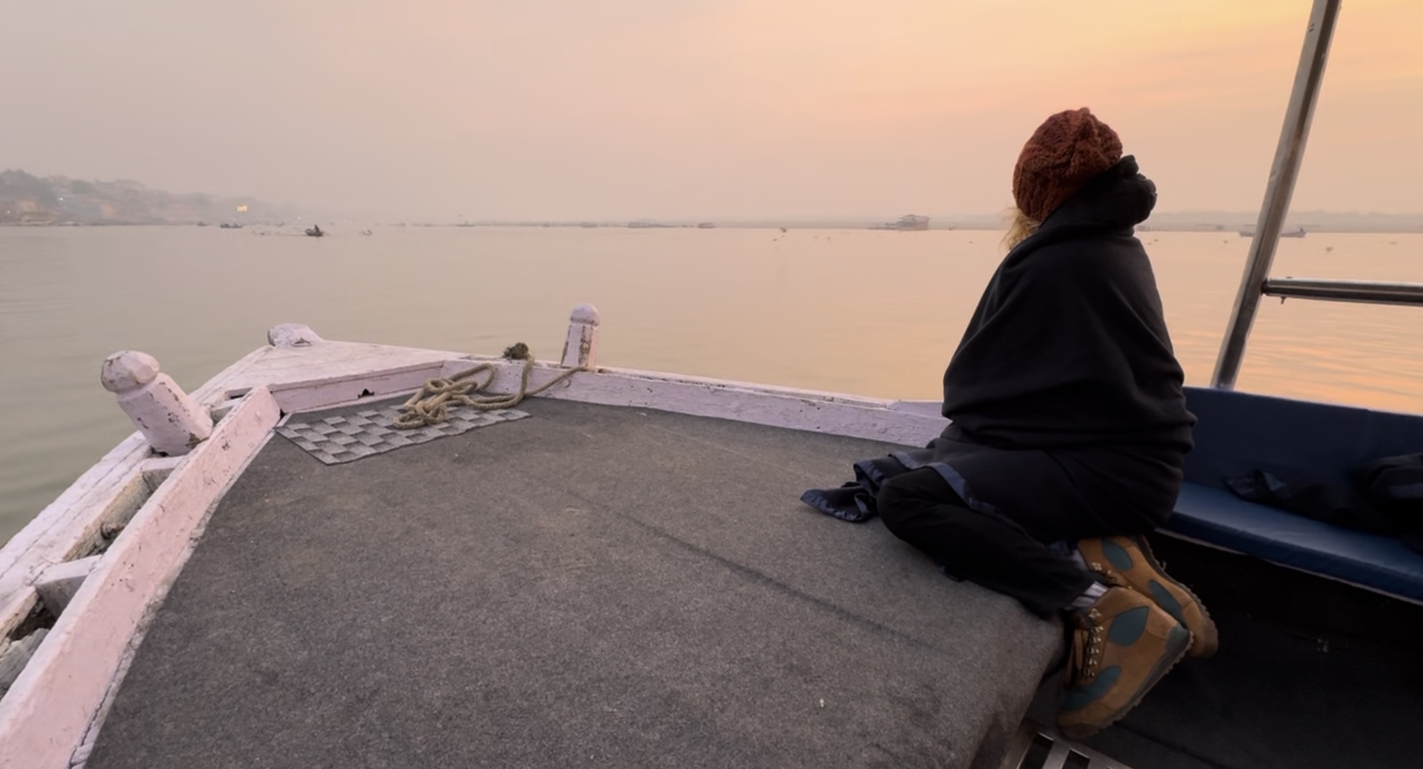 Tourist gazing at sunrise on the Ganges River in India