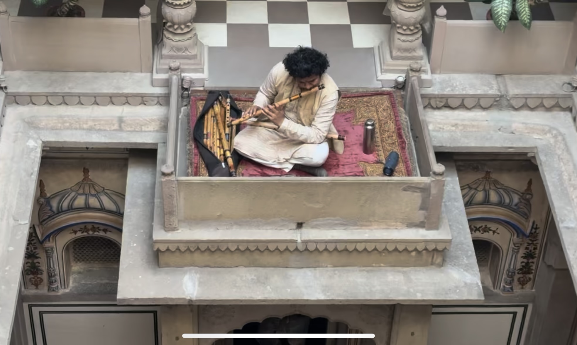 Man playing bansuri at BrijRama Palace in Varanasi, India