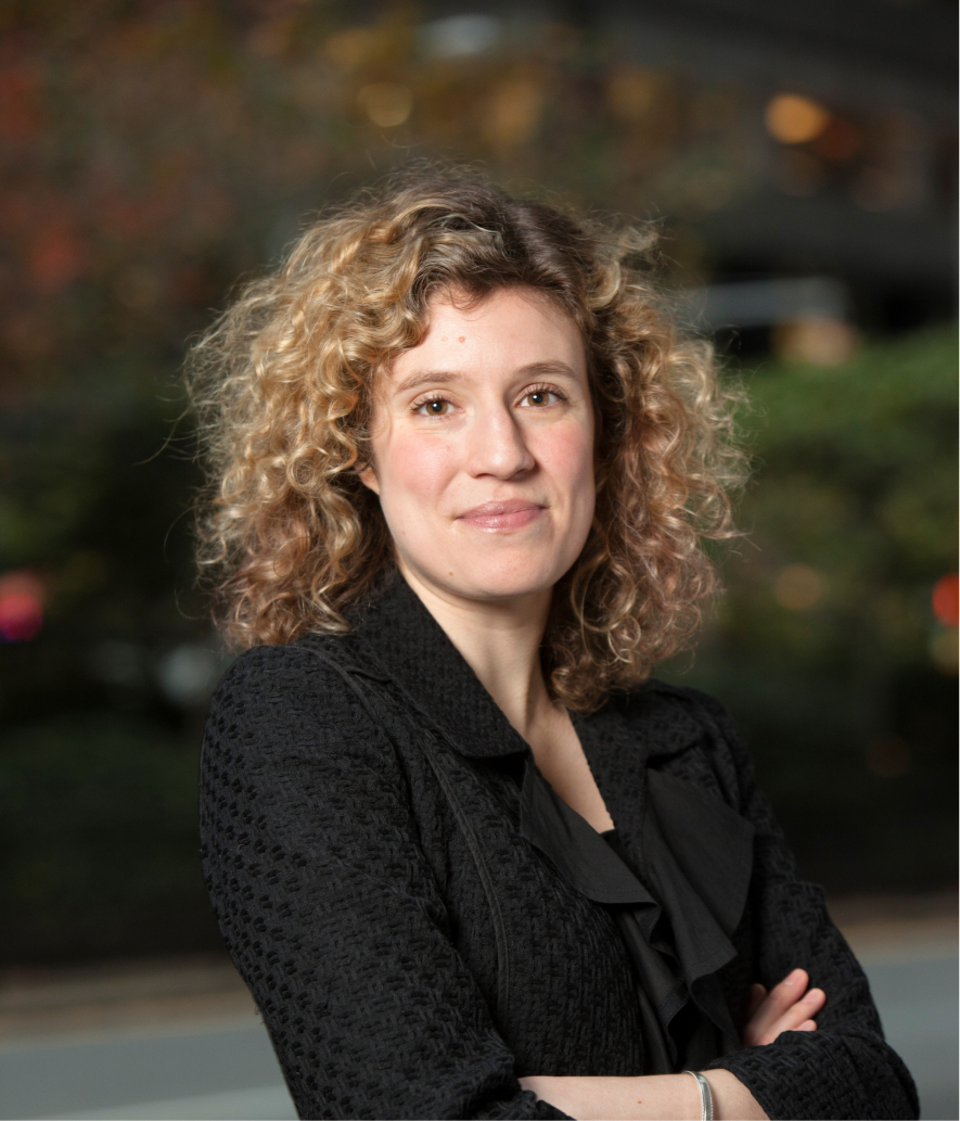 A woman with her arms crossed dressed in corporate attire in New York, New York, USA