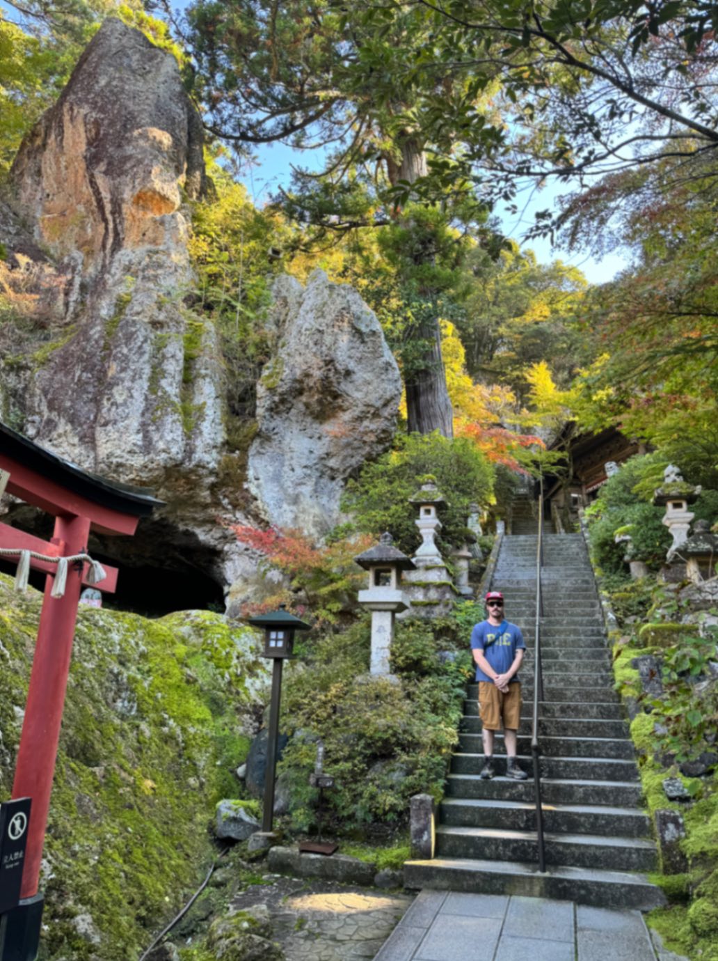 Man standing on steps at Natadera Temple in Komatsu, Japan